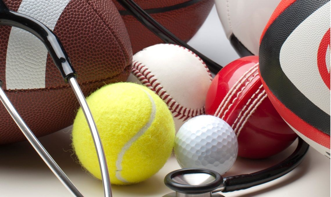 Different sports balls with stethoscope