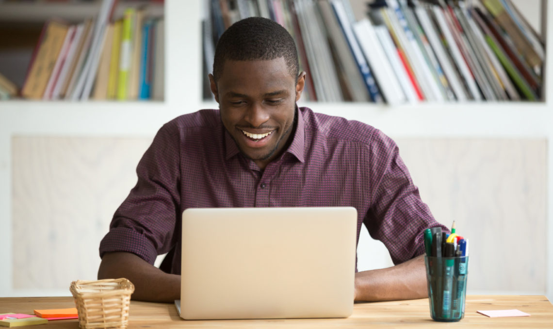 African man studying using computer